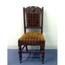 Set of six carved oak chairs. Arched back is decorated with lion's head and fruit carvings. Upho...