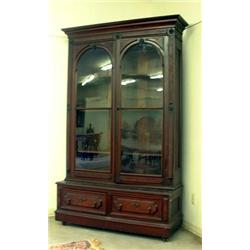 Walnut Victorian two-door bookcase. Raised and inset burled panels overall. Simple molded cornic...