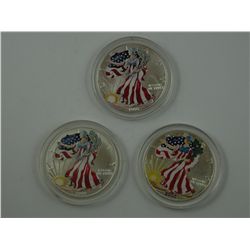 A trio of Uncirculated Colorized 1 oz. Silver Eagles