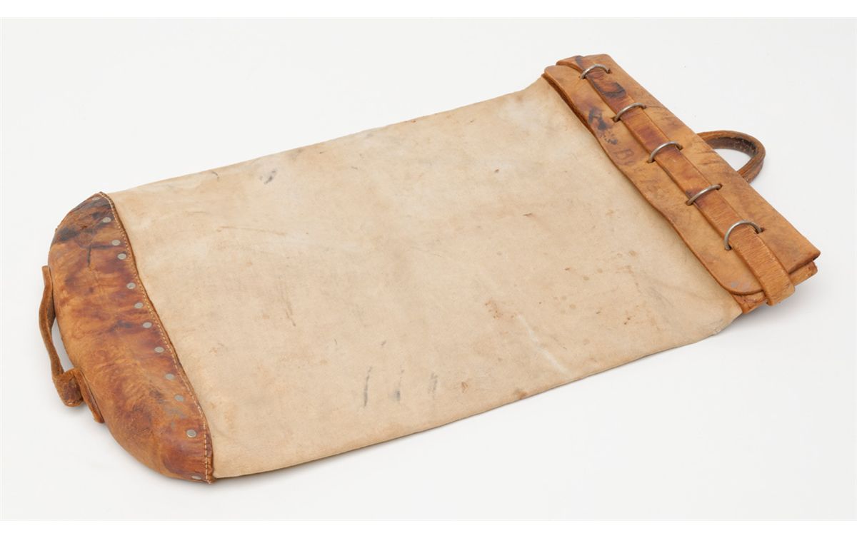 Old heavy duty commercial canvas mail bag with leather base, top