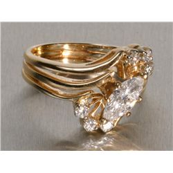 One 14k yellow gold ladies ring set with a marquee diamond weighing approx. 0.75ct and 6 side diamon