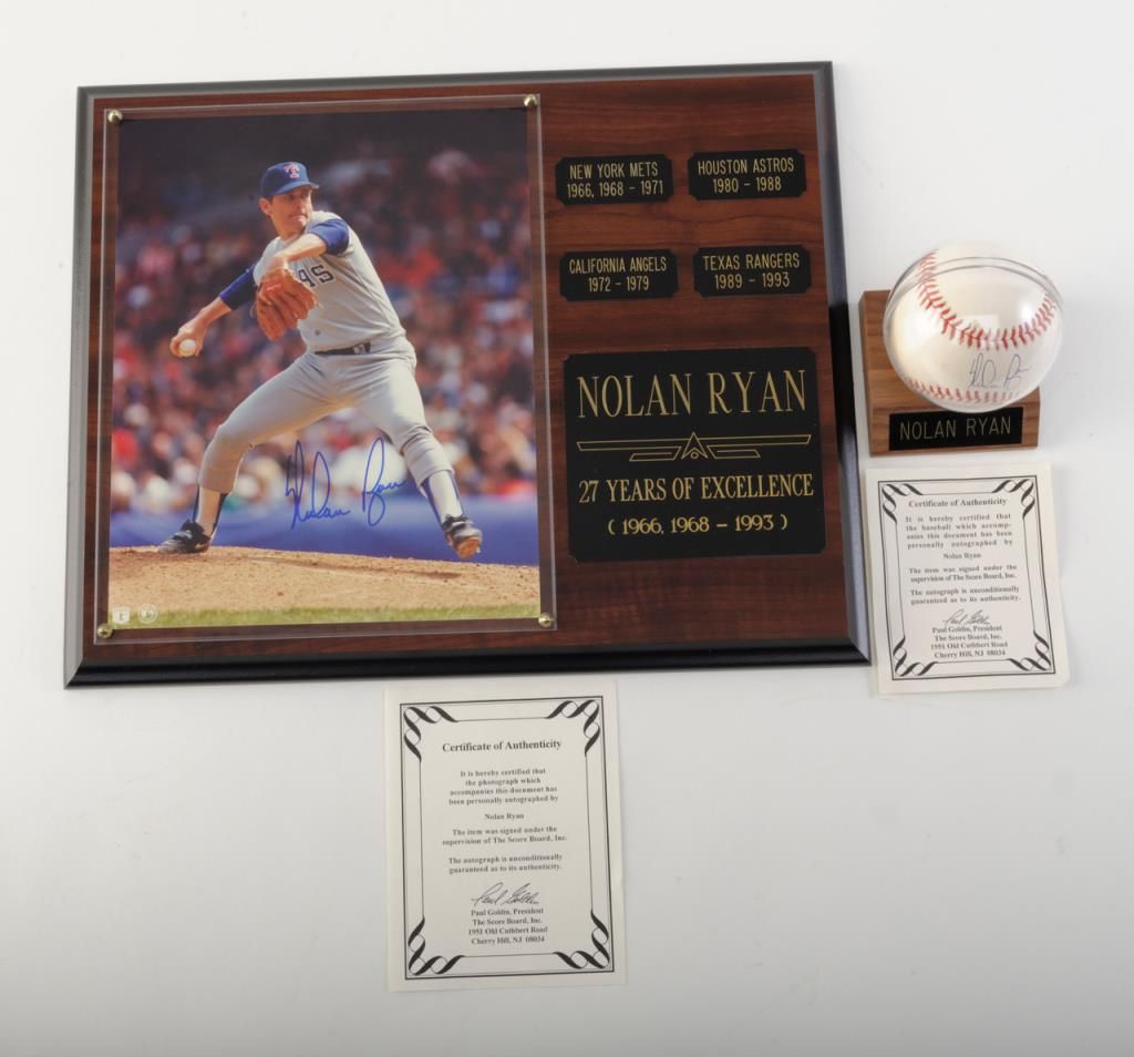 Nolan Ryan signed baseball in protective plastic on wood base with