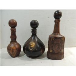 LOT 3 LEATHER COVERED GLASS LIQUOR DECANTERS