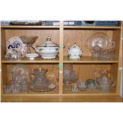 A large selection of vintage glassware and crystal including cake stand, pitchers, fruit bowl, cruet