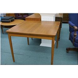 A Danish teak 36  square table with two extending  leaves