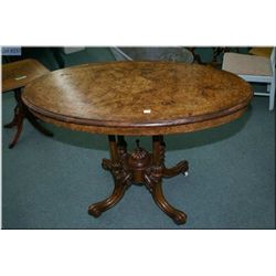 A Victorian burl walnut splayed leg occasional table with inlaid foliage and original porcelain cast