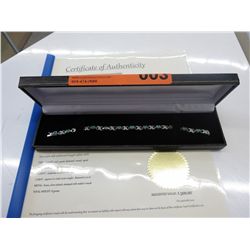 Ladies' diamond & emerald tennis bracelet.