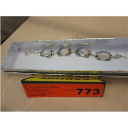Silver bracelet with four quartz cabochons