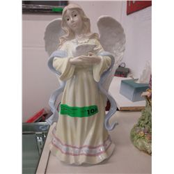 Glazed china figurine of a winged angel and dove
