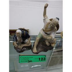 Two mud men statues