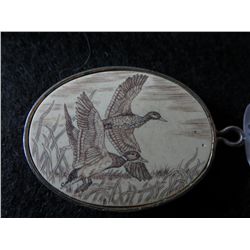 Collectible scrimshaw in a pendant case by Barlow