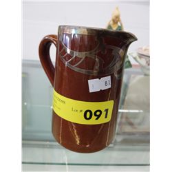 Vintage glazed jug with silver overlay