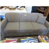 Image 1 : Grey upholstered hide-a-bed.