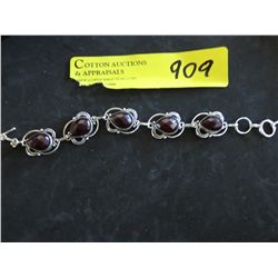Sterling bracelet with faceted red centers
