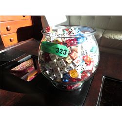 Large glass bowl full of dice and game pieces