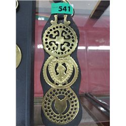 Horse brasses on a leather strap