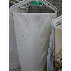 3 hangers containing vintage tableware and linen