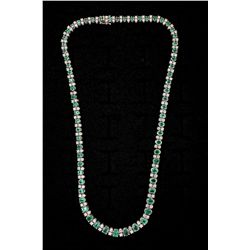 NECKLACE:  [1] 18KWG 171/2'' necklace set with 66 oval emeralds, approx. 12.00 cttw, light - moderat