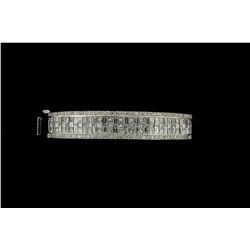 BRACELET: Ladys 18kw ''invisible'' set diamond bangle bracelet (hinged); 32 bag dias, approx 3.1mm x