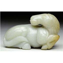 JADE CARVING OF A RECLINING HORSE.