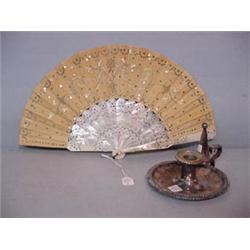 TWO PIECES: Pictured is an engraved mother-of-pearl fan with ecru silk embroidery and silver sequins