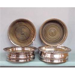 FOUR SILVERPLATE BOTTLE COASTERS