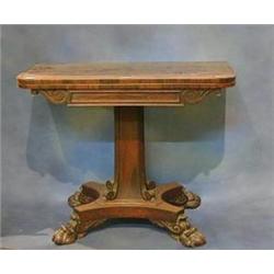 A William IV rosewood D shaped card table raised on a square chamfered column with triform base r...