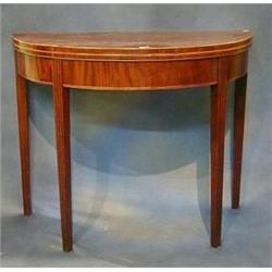 A Georgian mahogany demi-lune shaped tea table inlaid satinwood stringing and raised on square re...