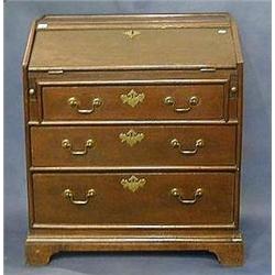 An 18th Century oak bureau the fall front revealing a fitted interior above 3 long graduated draw...