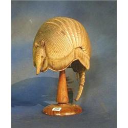 A preserved Armadillo shell converted for use as  a lamp shade £75-125...