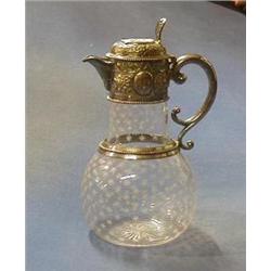 An Edwardian etched glass claret jug with embossed silver plated lid, £75-100...