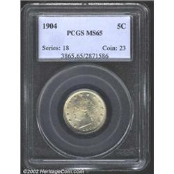 1904 5C MS65 PCGS. Steely grey surfaces with pastel yellow and violet undertones around Liberty's ha