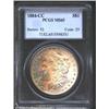 1884-CC S$1 MS65 PCGS. Well struck and minimally abraded with mottled gold, green, and steel-blue ob