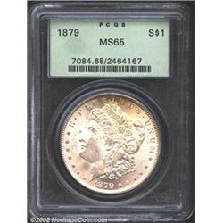 1879 S$1 MS65 PCGS. The borders have intermittent yellow-gold patina. A highly lustrous Gem with a b