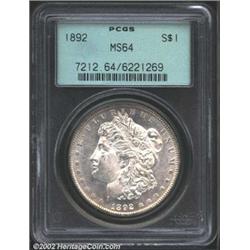 1892 S$1 MS64 PCGS. A brilliant and lustrous near-Gem that has a reasonable strike and light rose-go