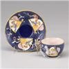 ENGLISH MAJOLICA teacup and saucer, circa 1875, with Japanese fan design on blue pebbled ground. …