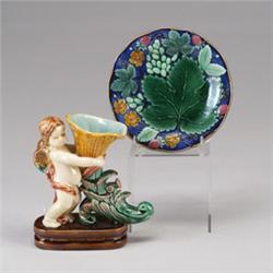 A Victorian style MAJOLICA vase, modern, modeled as a putto holding a cornucopia, together with G…