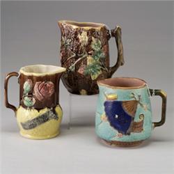 Three ENGLISH MAJOLICA jugs, circa 1875-1890, comprising a FIELDING-type with fan pattern, a rust…