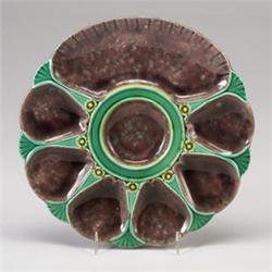 MINTONS MAJOLICA oyster plate, dated 1887, with six shell-form oyster wells and a large cracker w…