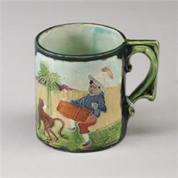 Continental MAJOLICA child's mug, probably Austrian, circa 1890, decorated with a hurdy-gurdy pla…