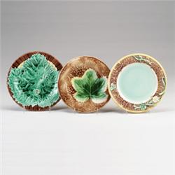 Three ENGLISH MAJOLICA dessert plates, circa 1875, with leaf and floral patterns in shades of gre…