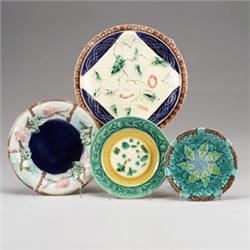 Four various MAJOLICA plates, comprising a napkin and dessert plate with cobalt blue ground, and …