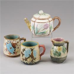 Four Victorian MAJOLICA items, circa 1875, comprising an ETRUSCAN pitcher with butterfly spout, a…