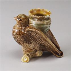 ENGLISH MAJOLICA figural vase, circa 1875, modeled as a martin holding an amphora, perched on a b…