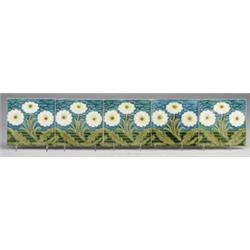 Five VILLEROY & BOCH frieze tiles embossed with white and yellow daisies with green leaves, on a …