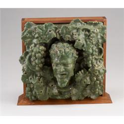 Rare and exceptional GRUEBY three-dimensional architectural faince tile depicting a head of Bacch…