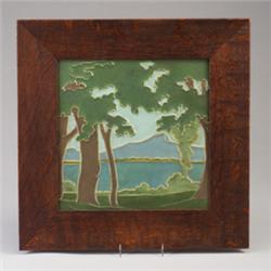 Fine and large ROOKWOOD architectural faience tile depicting a mountainous landscape with lake an…