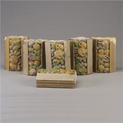 Six ROOKWOOD architectural faience border tiles embossed with fruit and flowers in matte polychro…