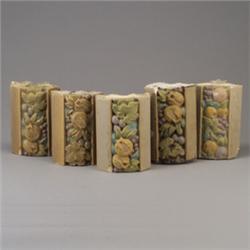 Five ROOKWOOD architectural faience border tiles embossed with fruit and flowers in matte polychr…