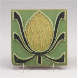 ROOKWOOD FAIENCE tile decorated in matte cuenca with a stylized fruit in yellow and black, on gre…